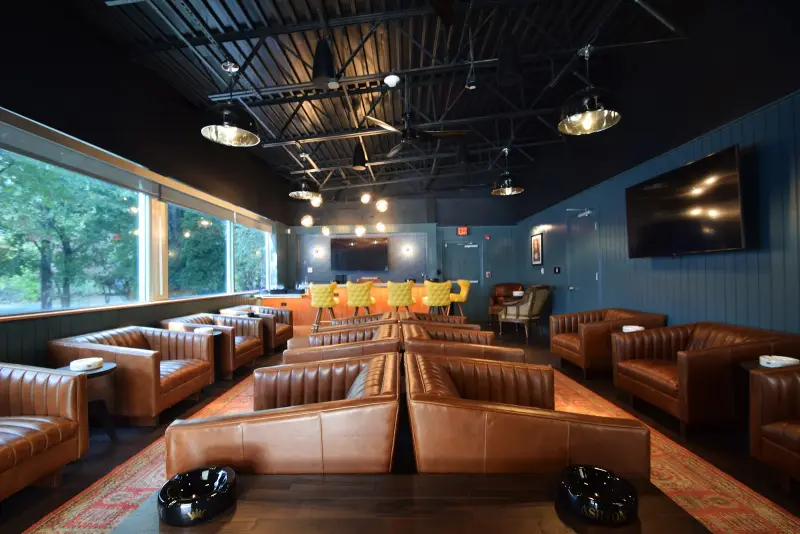 Leather chairs and the bar in the Tobacco Leaf lounge